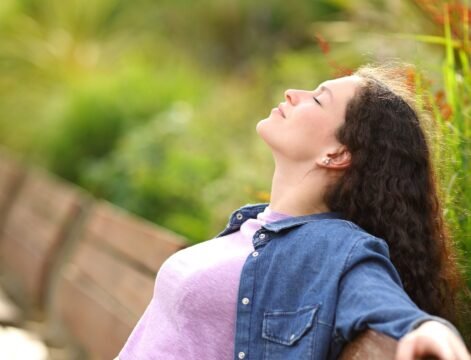 importance-of-rest-for-health - 1 Woman practicing conscious breathing outdoors for nervous system regulation and stress recovery