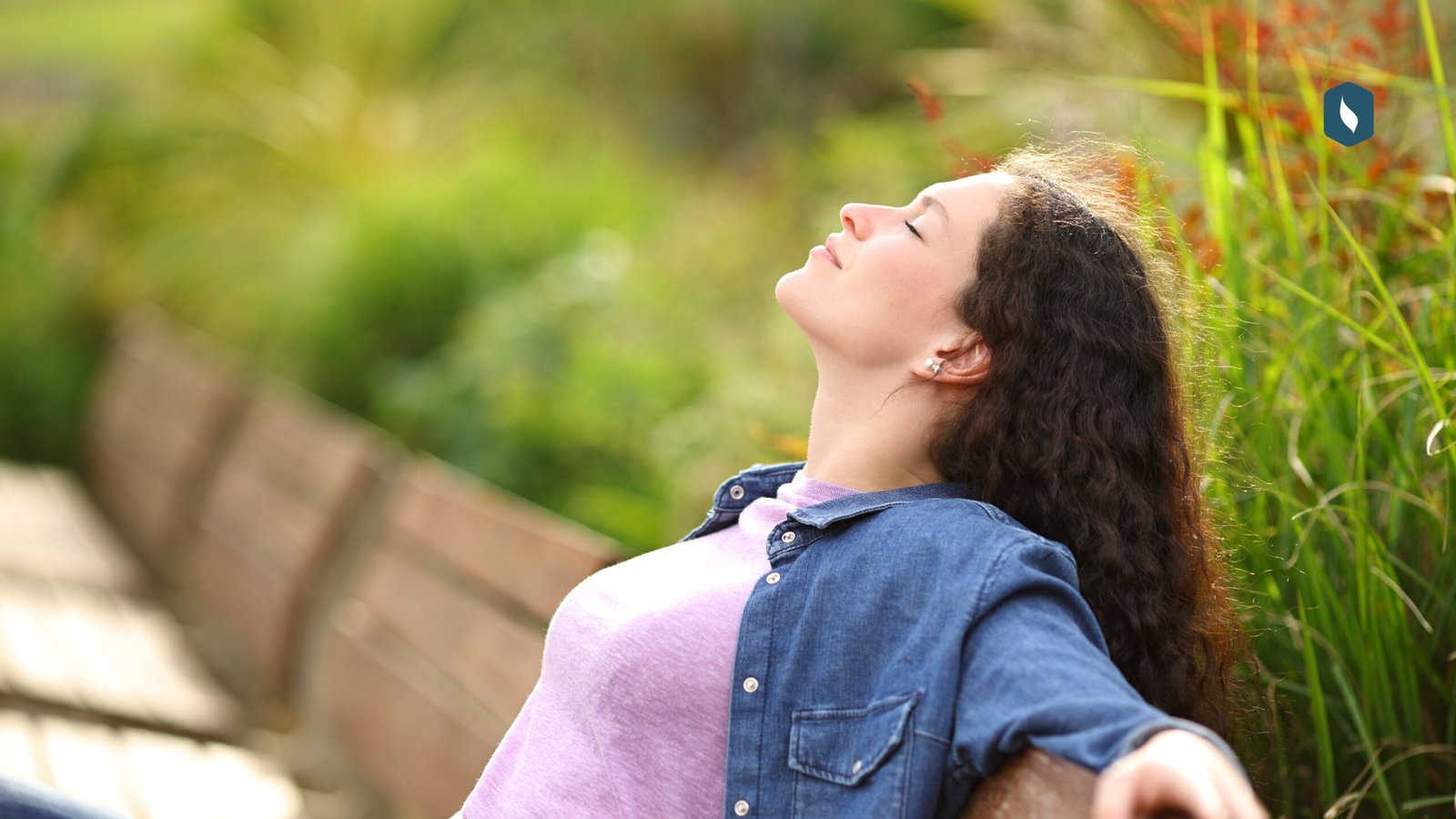 Woman practicing conscious breathing outdoors for nervous system regulation and stress recovery